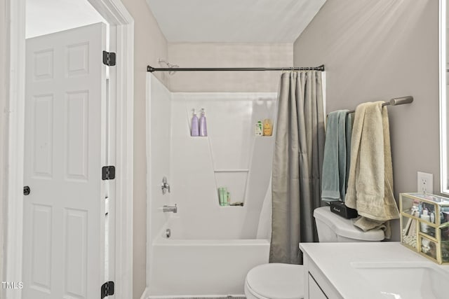 bathroom featuring vanity, shower / bath combo with shower curtain, and toilet