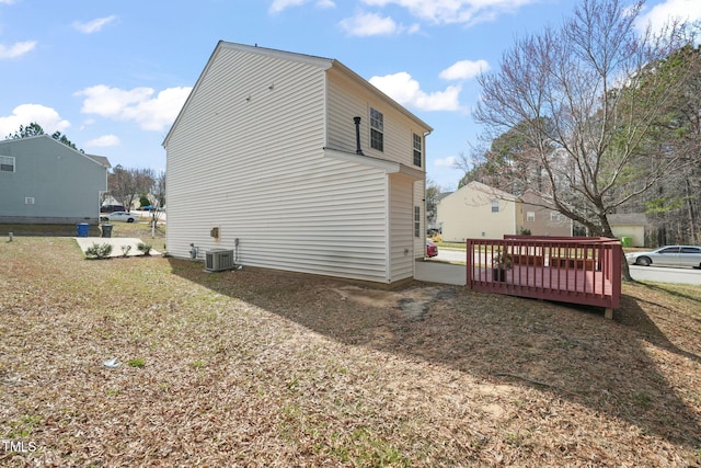 view of home's exterior featuring central AC unit and a wooden deck