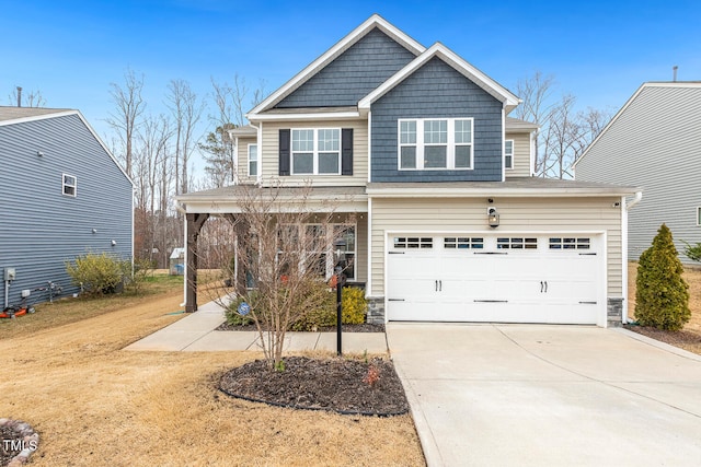 craftsman-style home featuring a porch, an attached garage, stone siding, and driveway