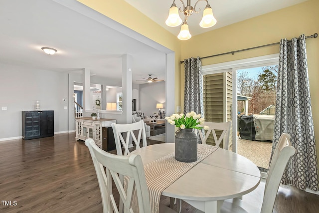 dining area with ceiling fan with notable chandelier, wood finished floors, and baseboards