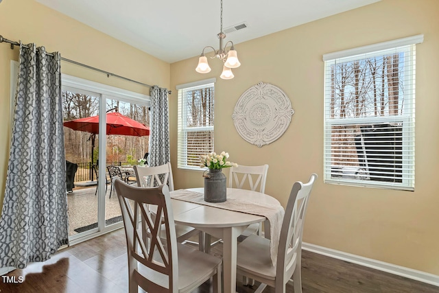 dining area with an inviting chandelier, baseboards, visible vents, and a wealth of natural light