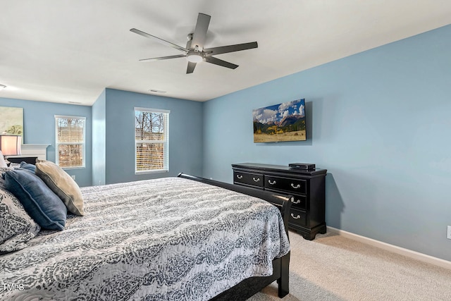 bedroom with ceiling fan, visible vents, baseboards, and light carpet