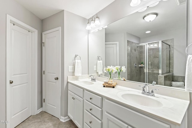 full bath featuring a sink, double vanity, and a shower stall