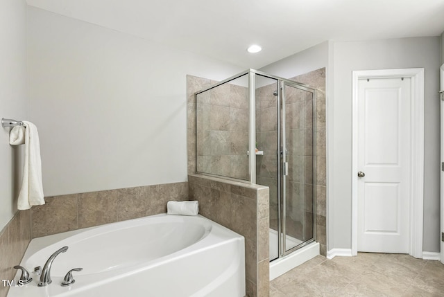 full bath featuring a stall shower, tile patterned flooring, and a bath