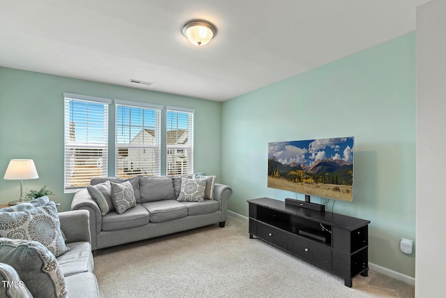 carpeted living room with visible vents and baseboards