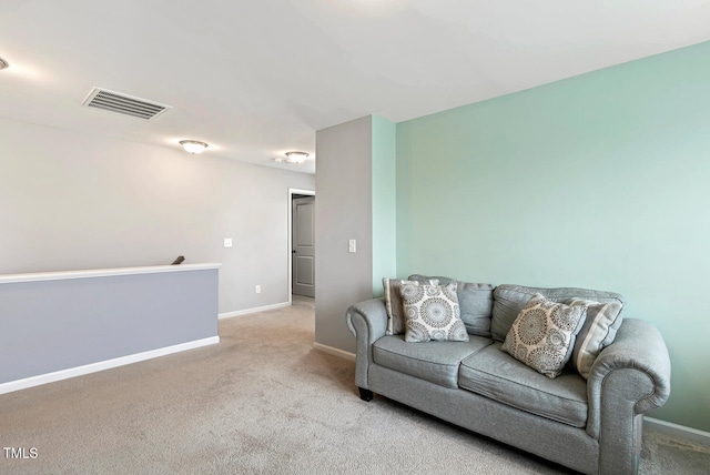 sitting room with carpet flooring, baseboards, visible vents, and an upstairs landing