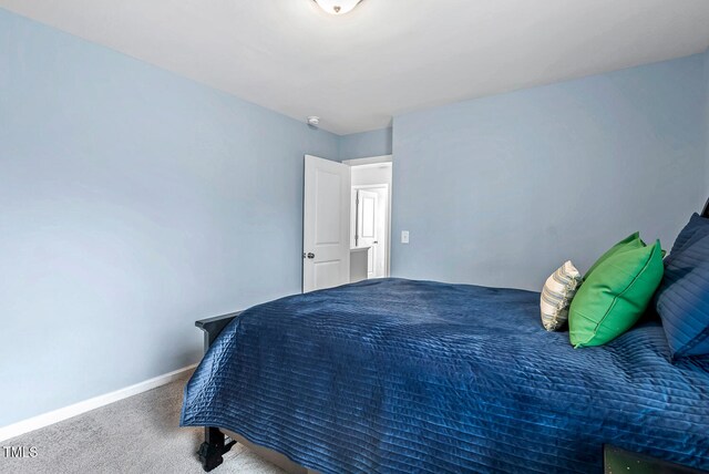 carpeted bedroom featuring baseboards