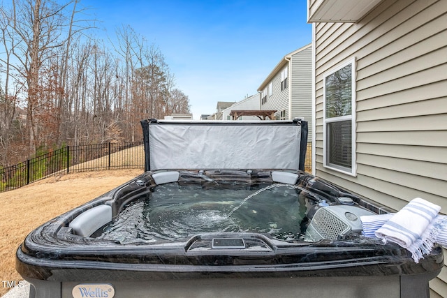 exterior space with a hot tub and fence