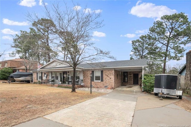 single story home with driveway, an attached carport, crawl space, covered porch, and brick siding