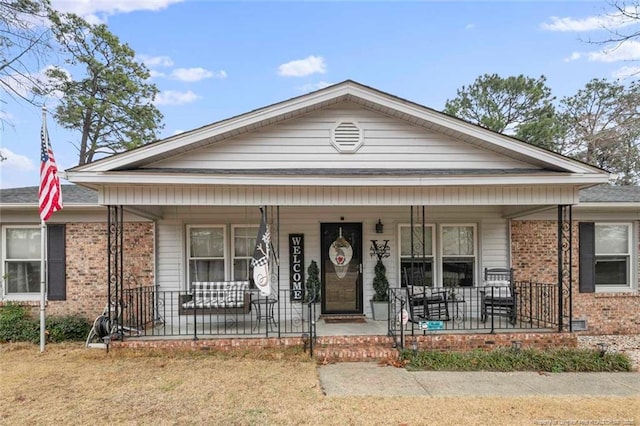 view of front facade featuring a porch and brick siding