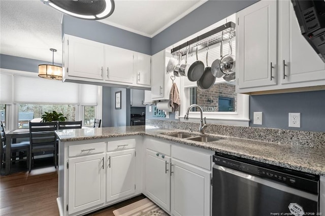 kitchen featuring a peninsula, wood finished floors, a sink, white cabinetry, and dishwasher