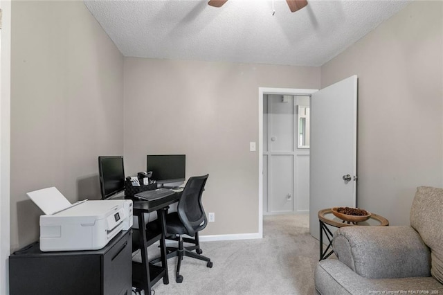 office with light carpet, ceiling fan, baseboards, and a textured ceiling