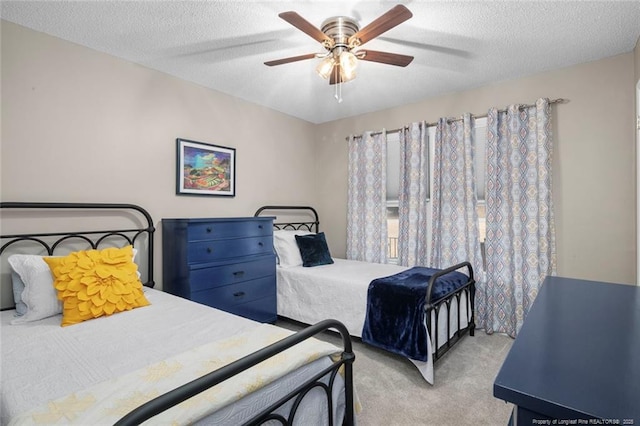 bedroom with a ceiling fan, carpet, and a textured ceiling