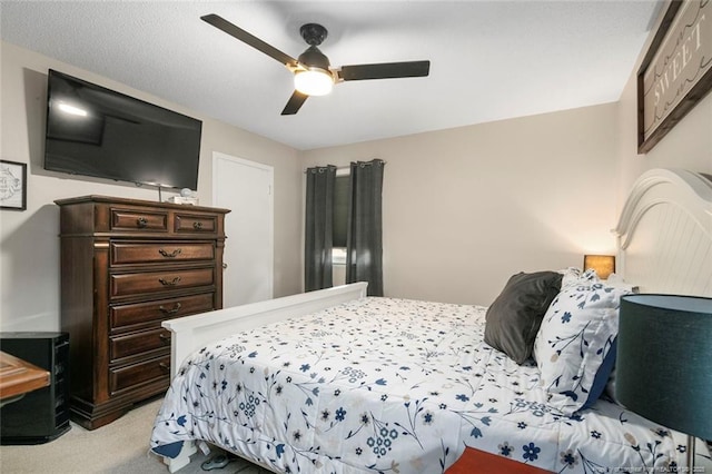 bedroom featuring light carpet and ceiling fan