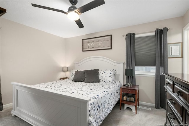 bedroom featuring light carpet, ceiling fan, and baseboards