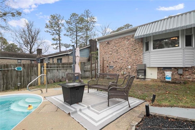 view of patio / terrace featuring a fire pit, fence, and a fenced in pool