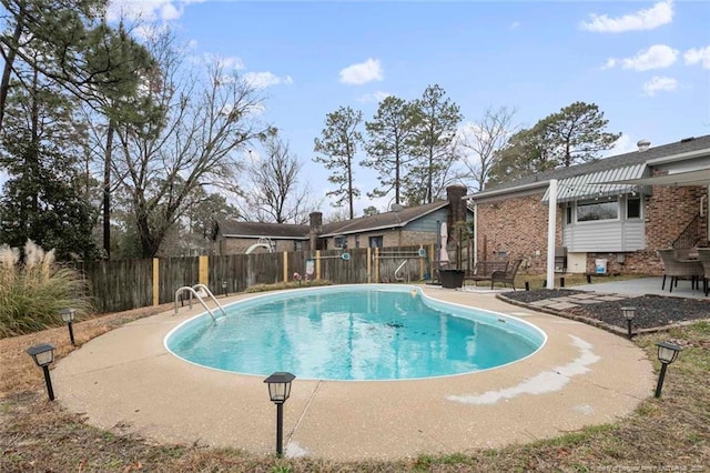 view of swimming pool featuring a patio area, fence, and a fenced in pool