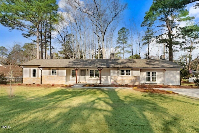 ranch-style home featuring a chimney and a front yard