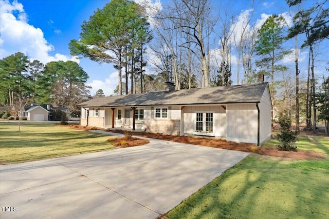 ranch-style house with a porch, a chimney, and a front lawn