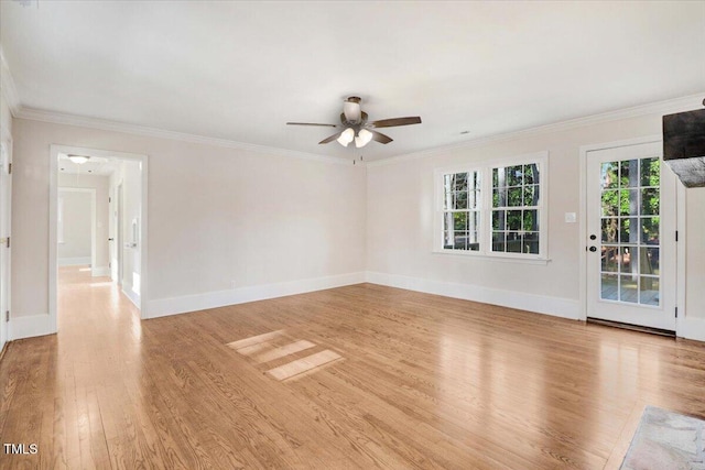 empty room with crown molding, light wood-style flooring, baseboards, and ceiling fan