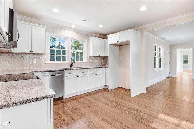 kitchen with crown molding, stainless steel appliances, light wood-style flooring, white cabinets, and a sink