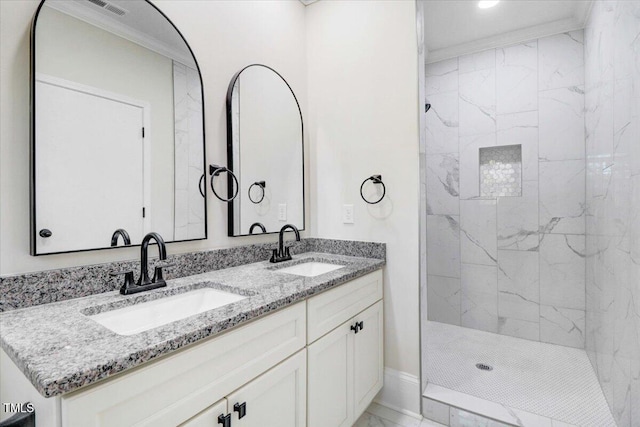 full bathroom featuring marble finish floor, ornamental molding, and a sink