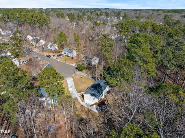 birds eye view of property featuring a forest view