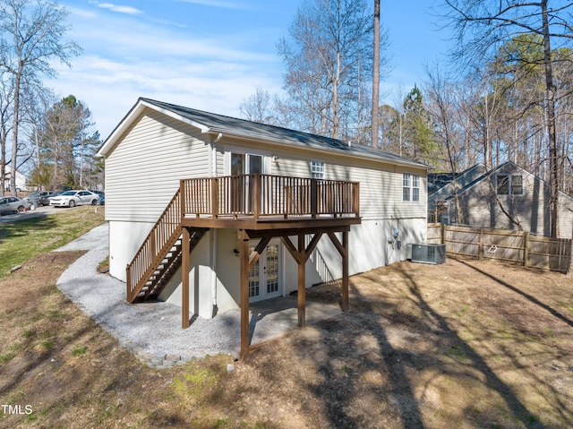 back of property with french doors, stairs, fence, a wooden deck, and central AC