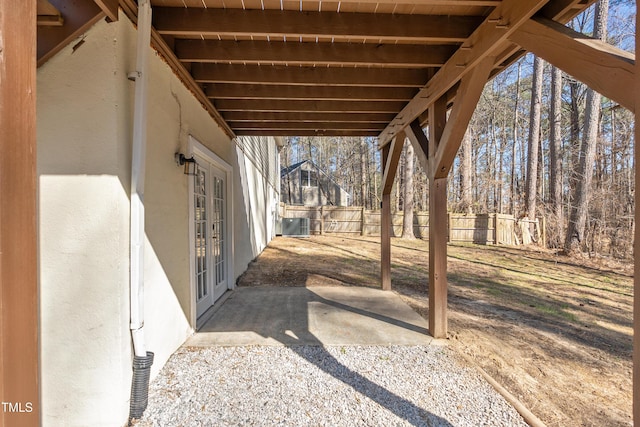 view of patio featuring central AC unit, fence, and french doors