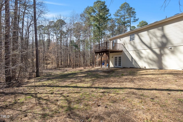 view of yard with french doors and a deck