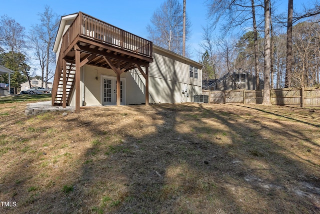 back of property featuring stairs, fence, and a deck