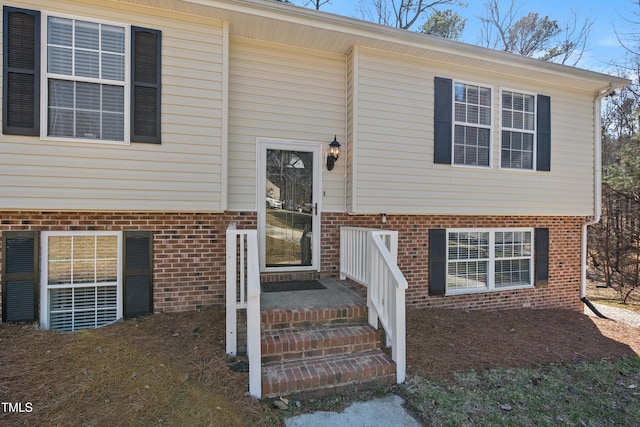 entrance to property featuring brick siding