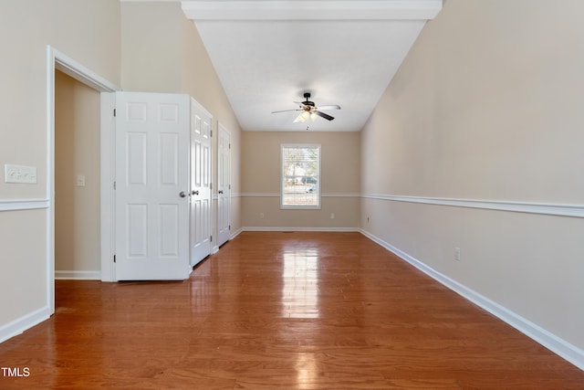 unfurnished room with baseboards, ceiling fan, and light wood finished floors