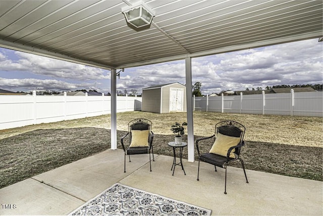 view of patio featuring a fenced backyard, an outdoor structure, and a storage unit