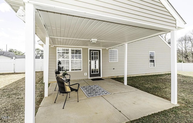 view of patio / terrace featuring a carport and fence