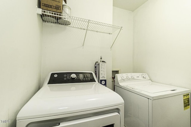 laundry area with laundry area and washer and clothes dryer