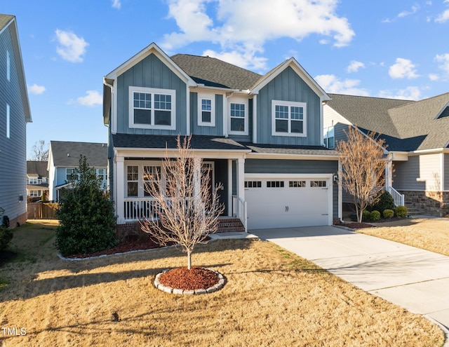 craftsman-style home with a front yard, a porch, an attached garage, concrete driveway, and board and batten siding