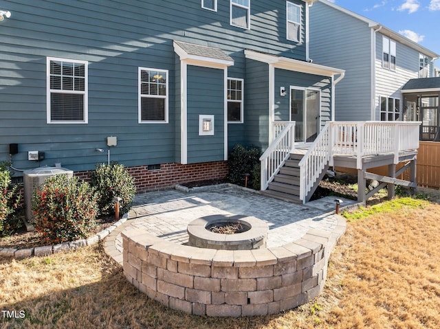 rear view of house with a wooden deck, an outdoor fire pit, stairs, crawl space, and central air condition unit