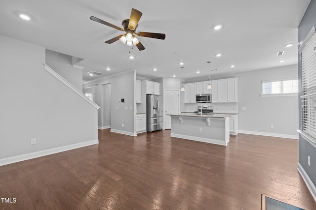 unfurnished living room with dark wood-style floors, recessed lighting, a ceiling fan, and baseboards