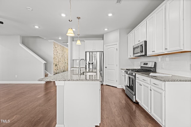 kitchen with decorative backsplash, dark wood-type flooring, appliances with stainless steel finishes, and white cabinetry