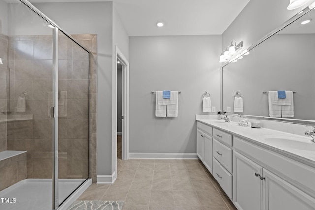 full bath featuring a shower stall, baseboards, and a sink