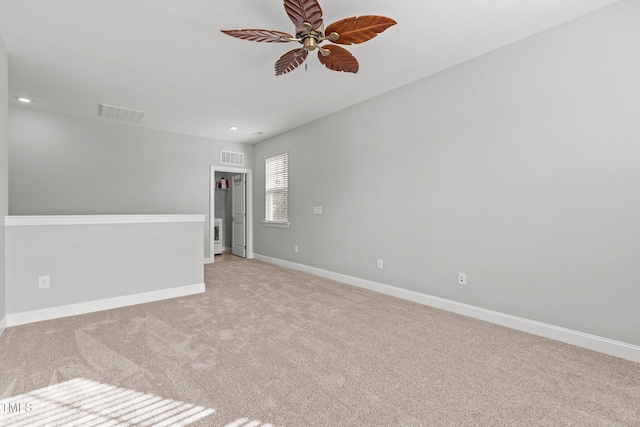 spare room with visible vents, baseboards, recessed lighting, ceiling fan, and light carpet