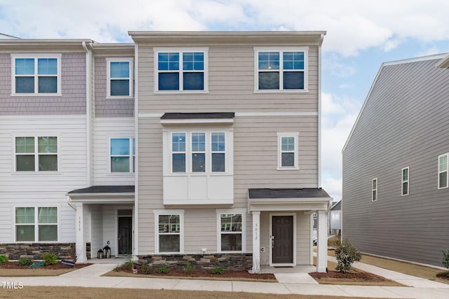 view of property featuring stone siding