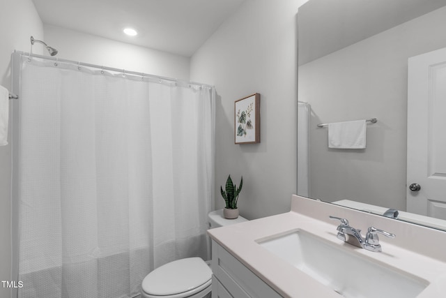 bathroom featuring toilet and vanity