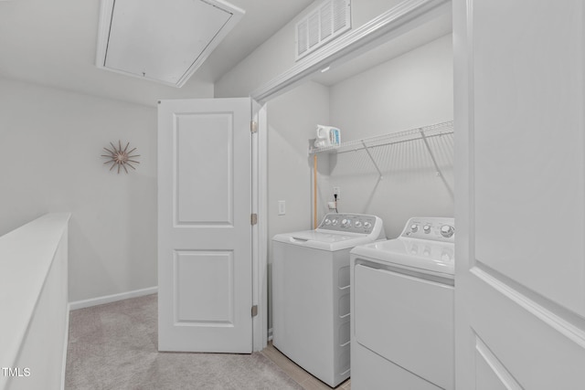 washroom with light carpet, laundry area, attic access, visible vents, and washer and dryer