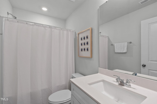 bathroom featuring visible vents, shower / tub combo, vanity, and toilet