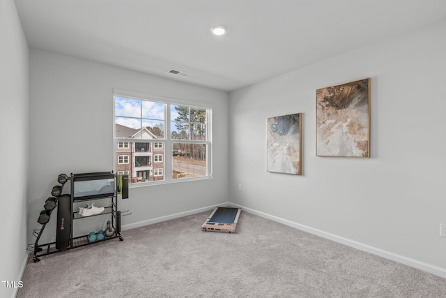 interior space with carpet flooring, visible vents, and baseboards