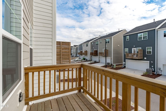 deck featuring cooling unit and a residential view