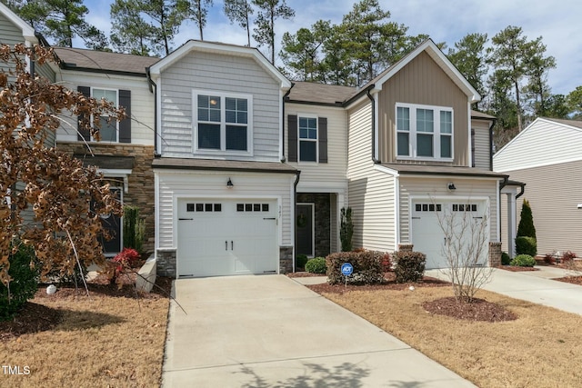 craftsman house with a garage, stone siding, and concrete driveway