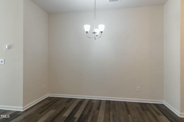 unfurnished dining area featuring a chandelier, dark wood finished floors, visible vents, and baseboards